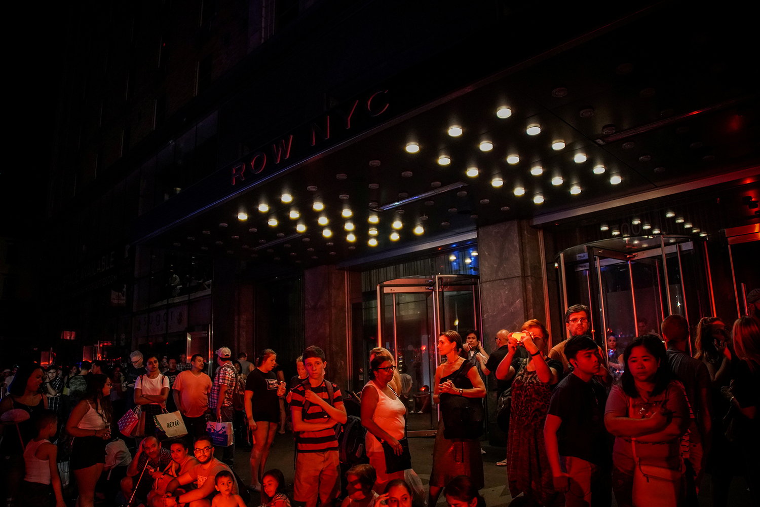 People are evacuated outside Row NYC hotel as a blackout affects